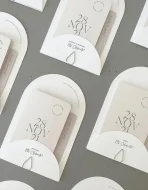 Rose gold teardrop shaped decorative paperclips on white stationery