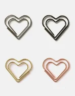 Heart paperclips clipping RSVP card to wedding invitation suite